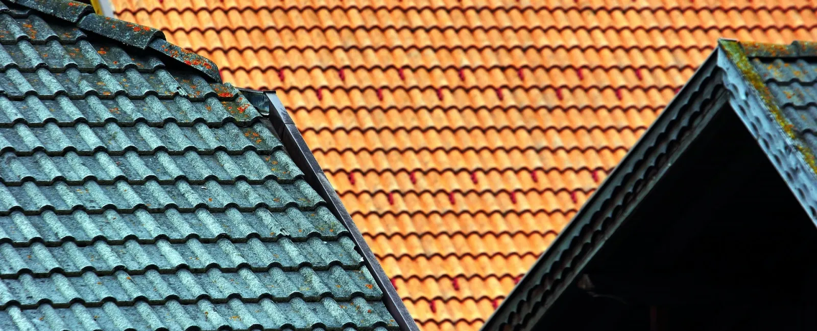 Teal and orange tile roofs side by side