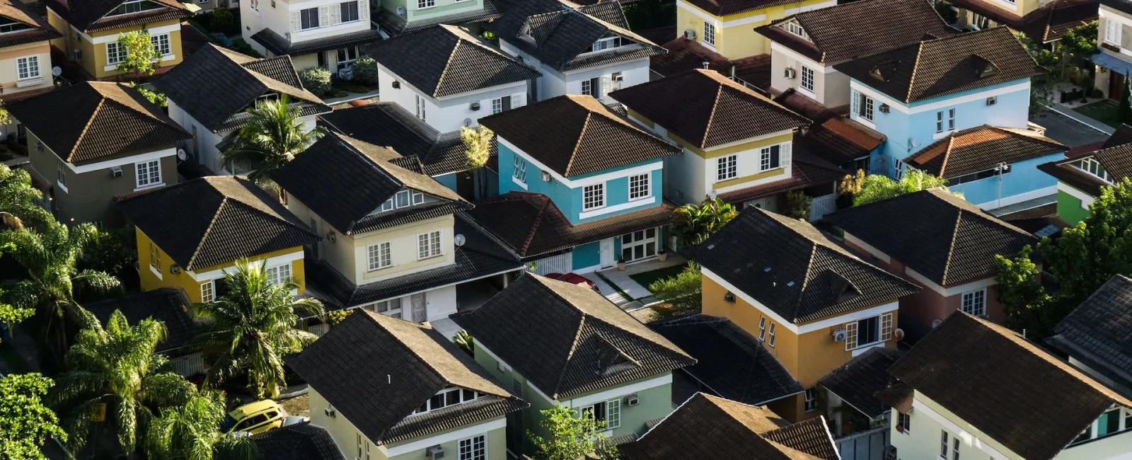 Aerial view of a neighborhood of homes with shingle roofs
