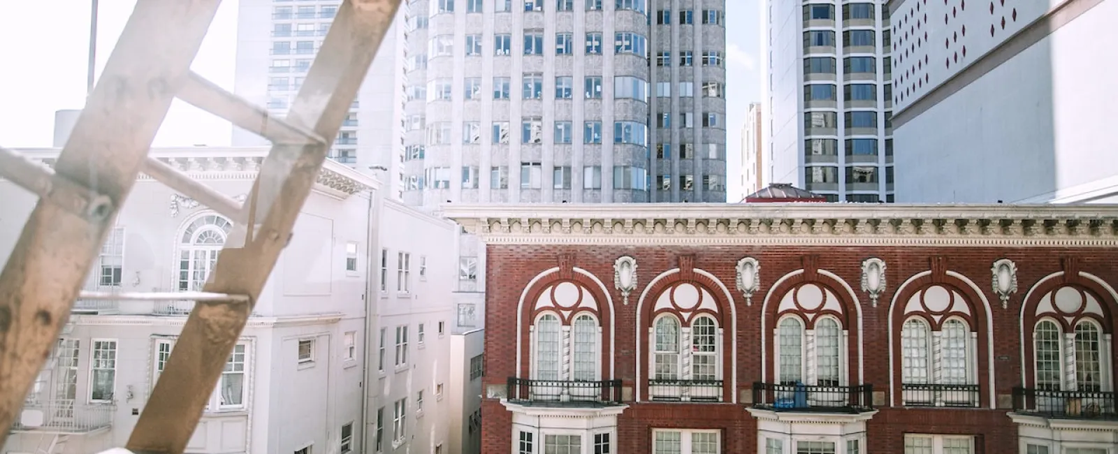 Brick commercial building in front of a glass office tower